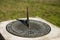 Weathered bronze sundial with inscription