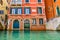 Weathered building facade on a picturesque canal in Venice Italy