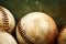 The weathered and coarse surface of antique baseballs on green background