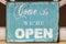 Weathered come in we\'re open sign