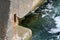 Weathered concrete blocks of pier with old rusty construction