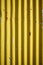 Weathered corrugated yellow rusty metal wall.