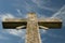 Weathered cross blue sky and wispy clouds