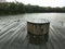 Weathered dark grey wooded seat on the wood deck in the afternoon beach