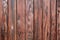 Weathered deep-brown painted wooden board texture