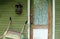 Weathered Front Door with Vintage Curtains on a Green Far
