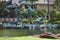 Weathered green copper statues and name sign with logo of worldwide hotel chain Hilton in Waikiki`s Hawaiian village.