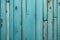 a Weathered green door with textured wood plank pattern