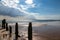 A weathered groyne in the ocean at Camber Sands, on a summer`s day