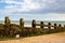 A weathered groyne on the sandy beach at Camber Sands, at low tide