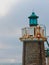 Weathered lighthouse in the port of Capbreton, Aquitaine, France. Faded photo for backgrounds and backdrops