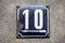 Weathered metal enameled plate of street address number 10