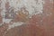 Weathered metal surface with damages and rust. An old red wall background. Abstract detailed texture.