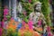 weathered monastery statue among vibrant flowers