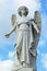 Weathered old twentieth century statue of Arch-angel Michael with broken sword in New York cemetery