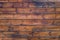 Weathered old vintage brown weathered  knotted wooden plank fence or wall, close up