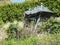 Weathered and overgrown pavilion in the garden