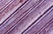 Weathered purple painted wooden surface.