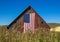 Weathered Red Barn with American Flag