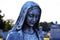 Weathered religious marble Virgin Mary statue in church cemetery graveyard memorial