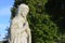 Weathered religious marble Virgin Mary statue in church cemetery graveyard memorial