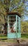 Weathered and rusted disused phone booth