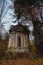 A weathered spooky crypt in the forest late autumn