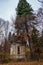 A weathered spooky crypt in the forest late autumn