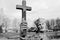 Weathered statue of a bishops hand holding Crucifix monochrome image