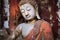 weathered statue of buddha in meditative pose