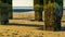 Weathered stone poles at the beach, view on the ocean, landscape of the belgian coast