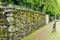 Weathered Stone Wall and Brick Sidewalk