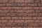 Weathered texture of stained old dark brown and red brick wall background, grungy rusty blocks of stone-work technology, colorful