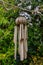 A Weathered Wind Chime Hangs on Tree Branch