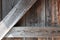 Weathered wood barn door background with vertical, horizontal, and angled members, creative copy space options