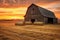 weathered wooden barn with hay bales at sunset