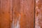 Weathered wooden boards with traces of orange paint