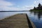 Weathered wooden dock into scenic lake outdoor nature background