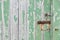 Weathered wooden door peeling green paint