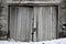 Weathered wooden doorway of an old concrete shed