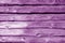 Weathered wooden fence in purple tone
