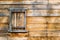 Weathered wooden wall with shuttered window on colonial barn