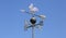 Weathervane on blue sky background