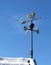 Weathervane and blue sky on the roof in winter