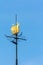 Weathervane in the form of ship over blue sky
