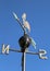 weathervane with rooster above an arrow and the four cardinal p