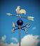 weathervane with rooster above an arrow and the four cardinal p