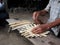 Weaving bamboos products on a ground base wooden work place of rural village ethnic group