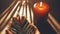 Web banner 16:9 aspect ratio - hands held in prayer with a palm frond and a candle