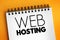 Web hosting - Internet hosting service that hosts websites for clients, text concept on notepad